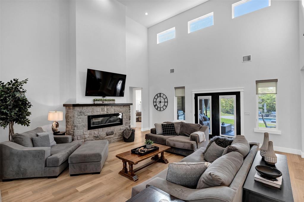 175 Bittersweet Trail Weatherford, TX 76088 - Photo 10 of 40 a living room with furniture a fireplace and a flat screen tv