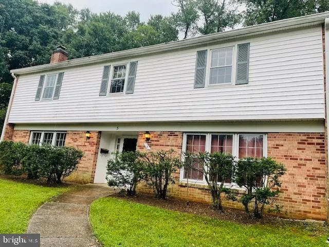 a view of a grassy field with trees in the background
