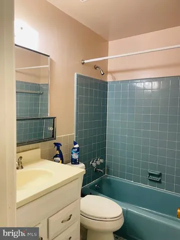 a white toilet sitting next to a bathroom sink