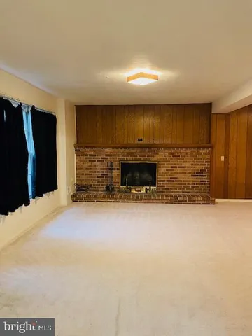 a view of empty room with a fireplace