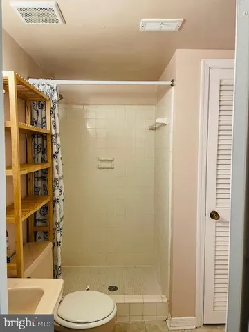 a bathroom with a shower and a toilet