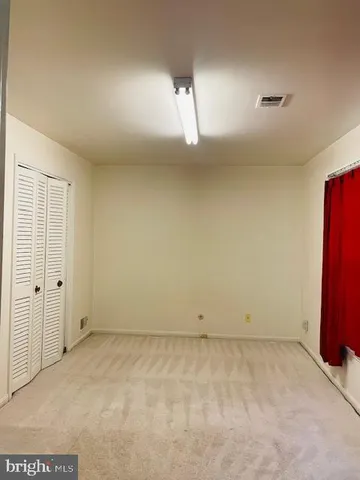 an empty room with wooden floor