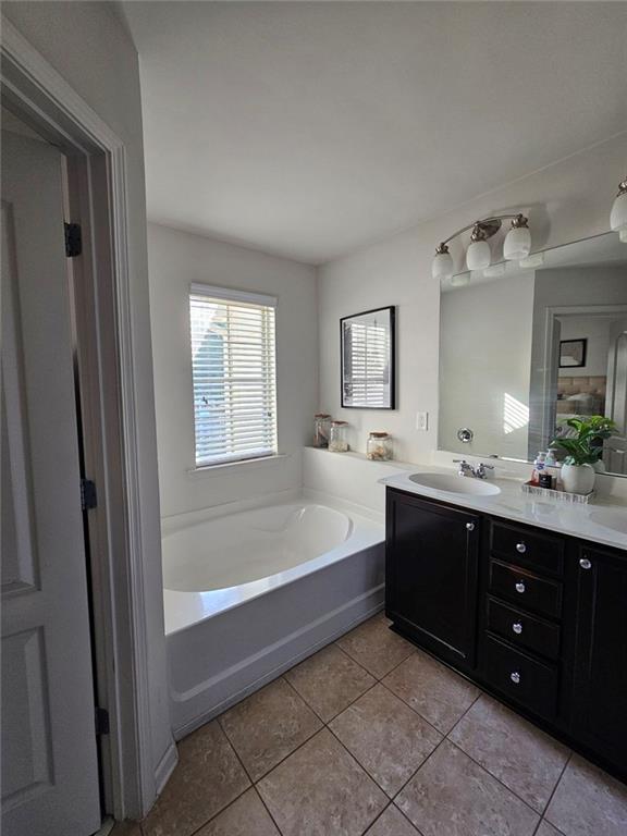 5747 Radford Loop Fairburn, GA 30213 - Photo 25 of 36 a spacious bathroom with a tub sink shower and mirror