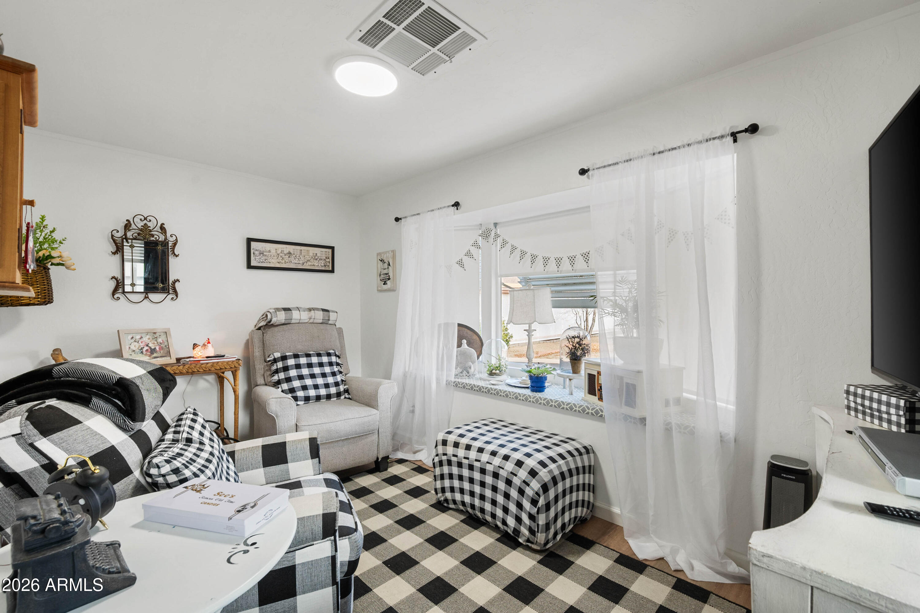 1165 Rocking M Lane, Unit 1165 Prescott Valley, AZ 86327 - Photo 17 of 30 a bedroom with furniture and a window