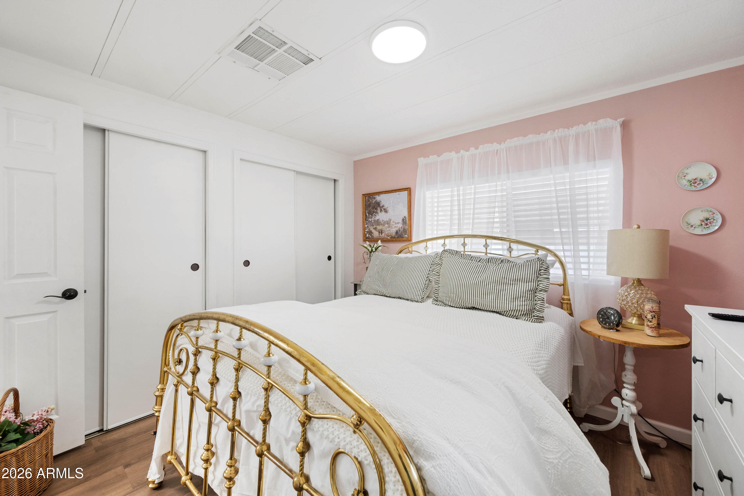 1165 Rocking M Lane, Unit 1165 Prescott Valley, AZ 86327 - Photo 20 of 30 a bedroom with a bed and a table