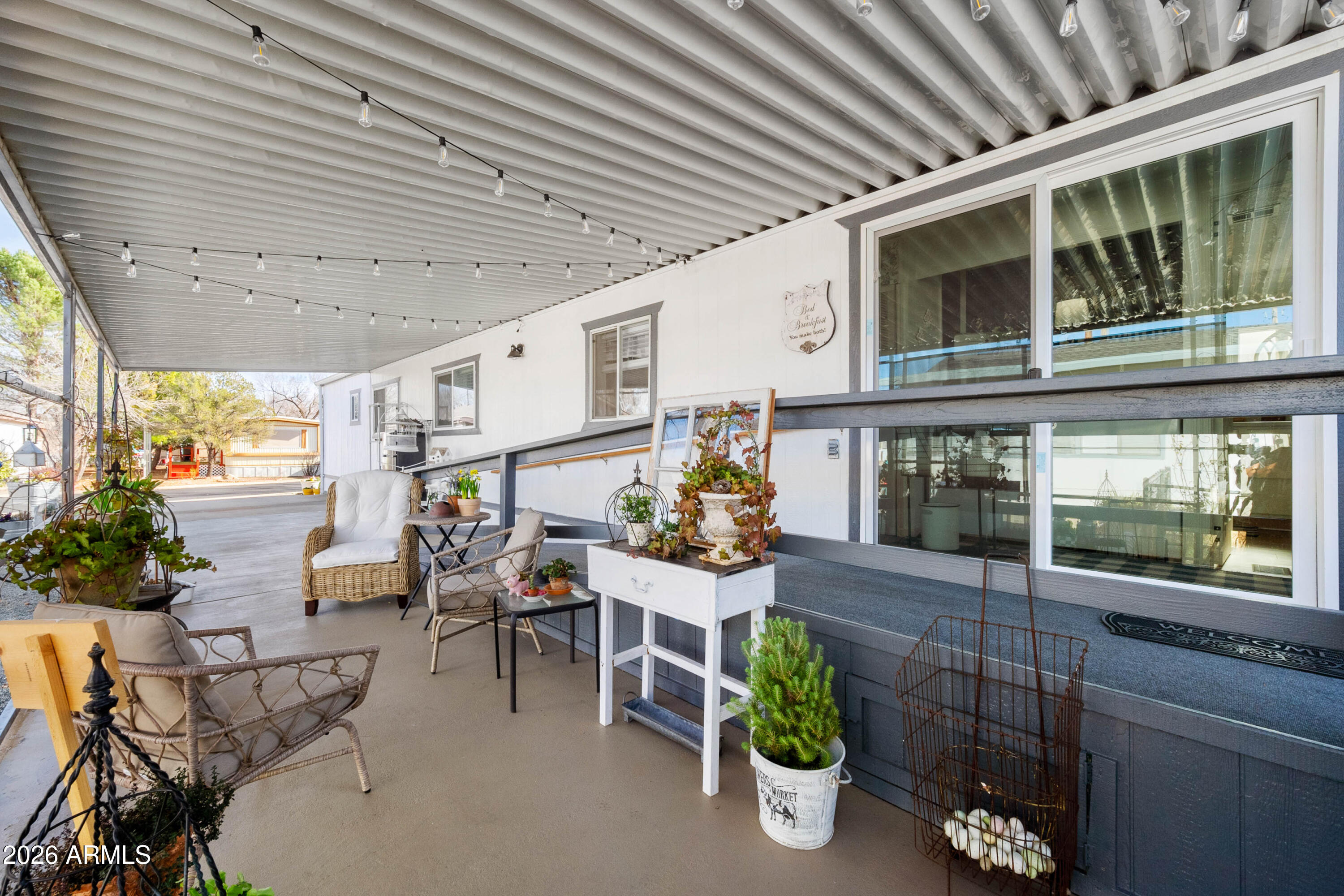 1165 Rocking M Lane, Unit 1165 Prescott Valley, AZ 86327 - Photo 27 of 30 a view of a porch with chairs and potted plants