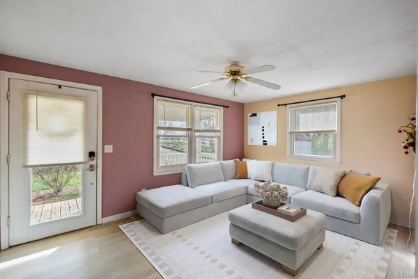 a view of a dining room with furniture and chandelier