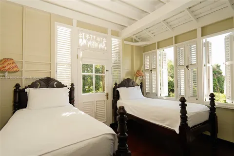 a bedroom with a large bed and a large window
