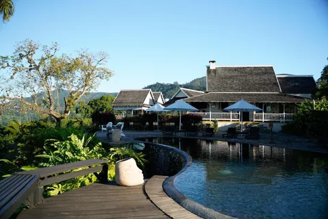 a swimming pool view with a seating space