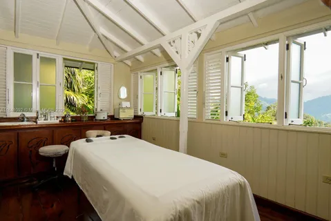 a bedroom with a bed and a large window with outer view