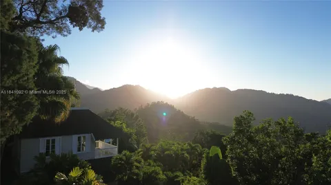 a view of a house with a mountain in front of it