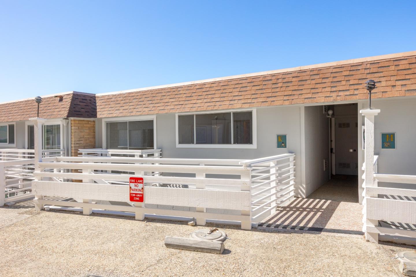 230 Rio Del Mar Boulevard, Unit K Aptos, CA 95003 - Photo 4 of 29 a view of a house with a barbeque and wooden stairs