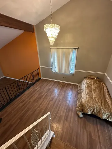 a view of bedroom with wooden floor