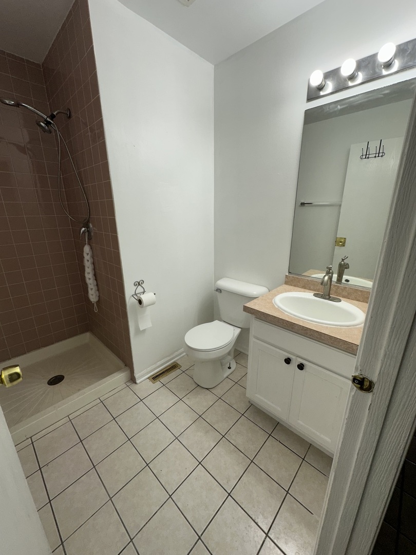 16627 Carse Avenue Harvey, IL 60426 - Photo 16 of 23 a bathroom with a double vanity sink mirror and toilet