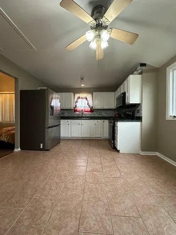 a kitchen with stainless steel appliances a stove refrigerator and sink