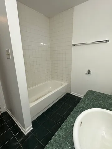 a bathroom with a tub and shower