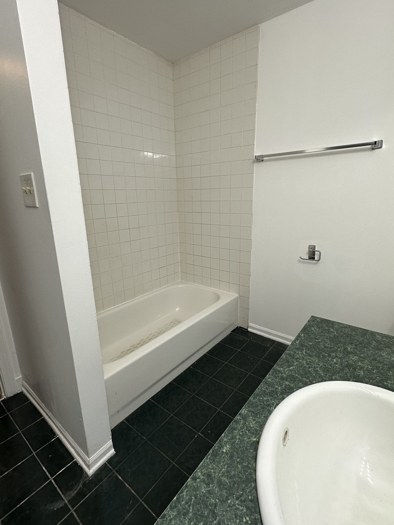 16627 Carse Avenue Harvey, IL 60426 - Photo 9 of 23 a bathroom with a tub and shower