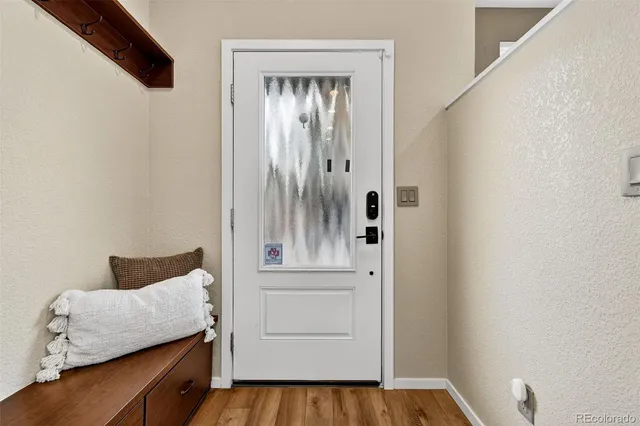 a view of walk in closet with wooden floor