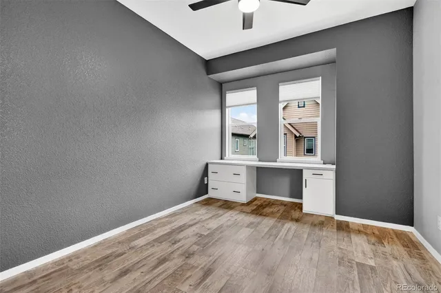 an empty room with closet and windows