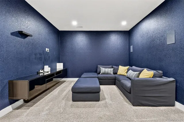 a living room with furniture and a lamp