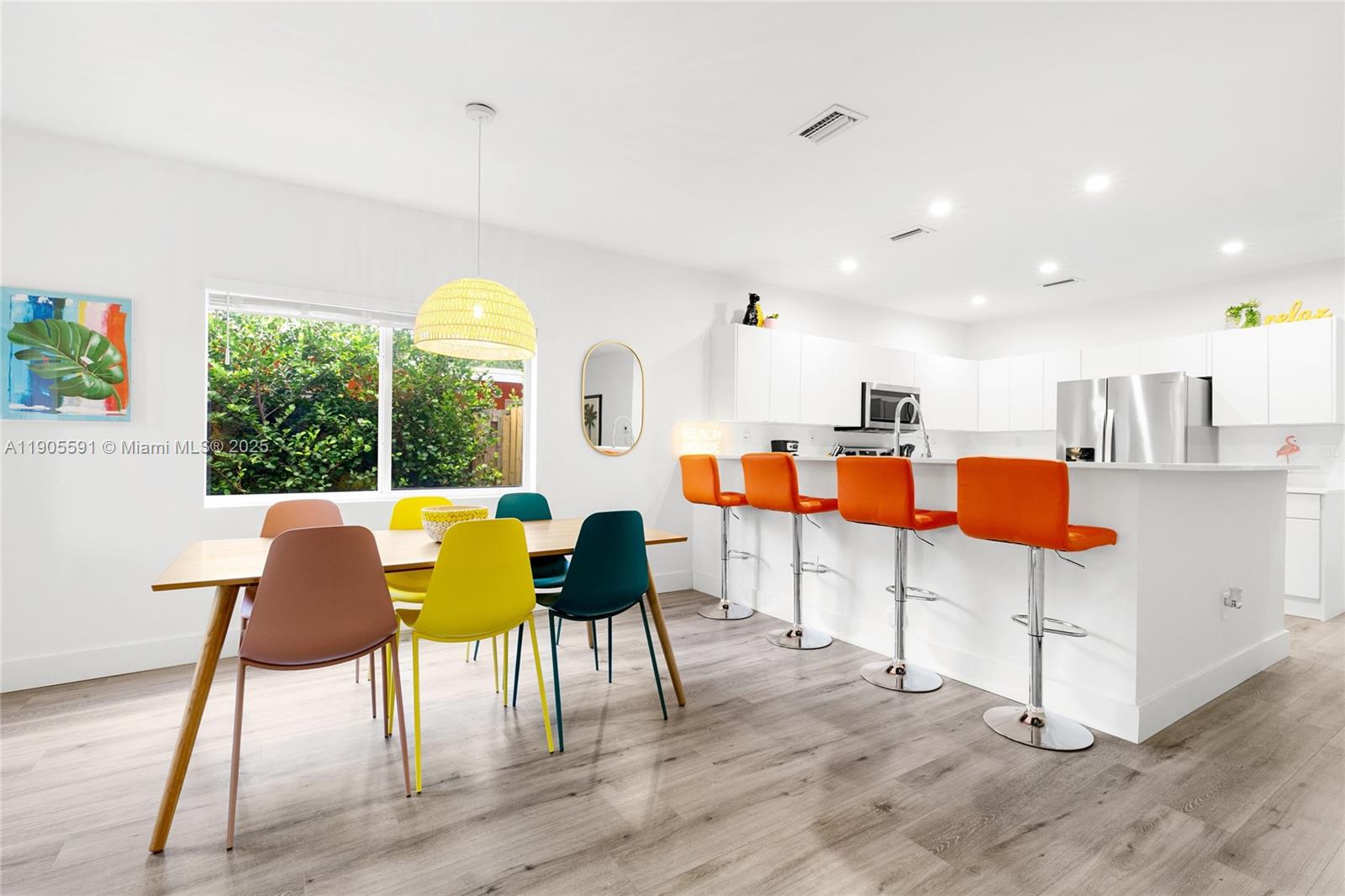 1123 Northeast 23rd Terrace Pompano Beach, FL 33062 - Photo 11 of 35 a living room with furniture and kitchen view with wooden floor