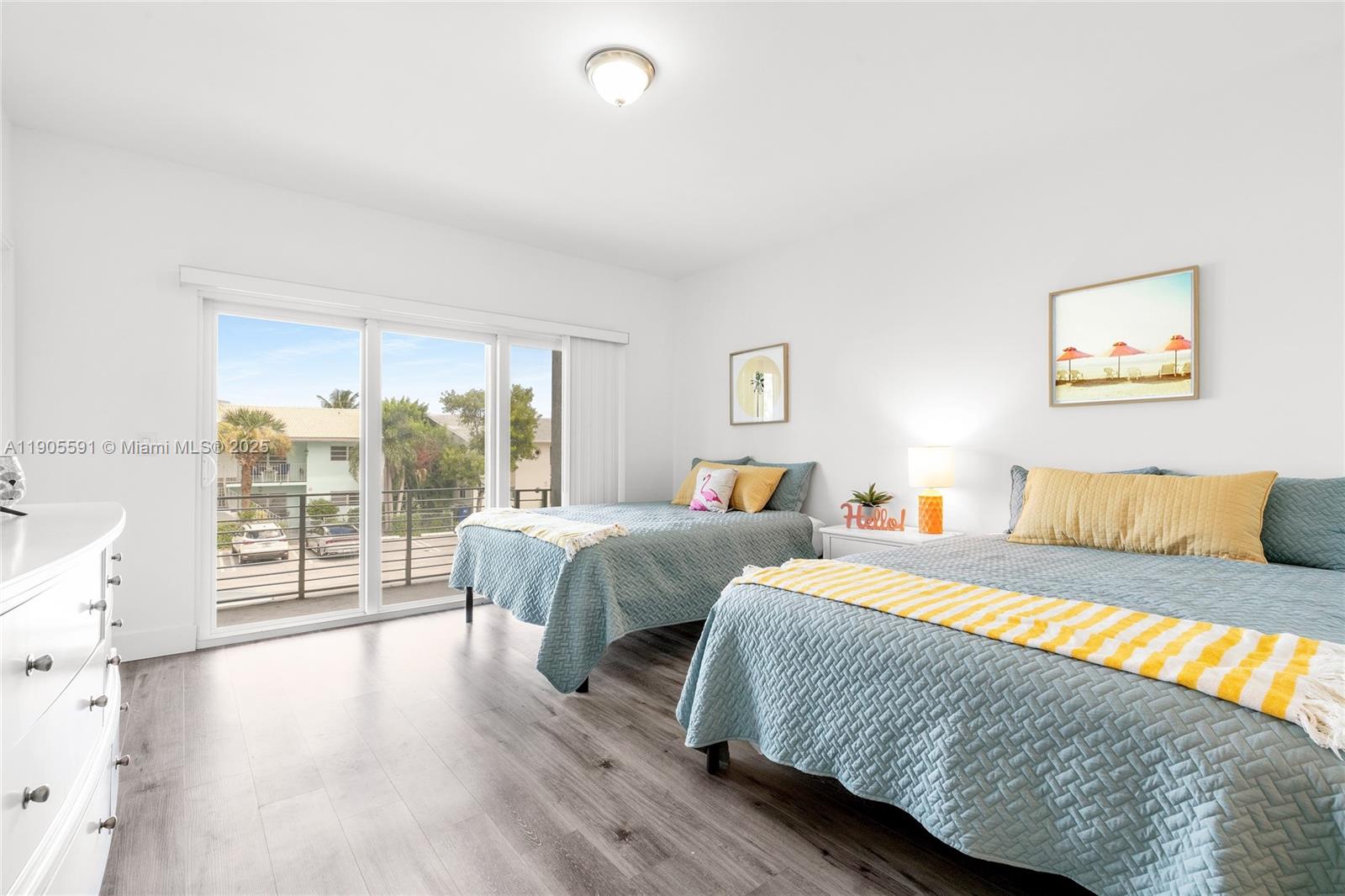 1123 Northeast 23rd Terrace Pompano Beach, FL 33062 - Photo 21 of 35 a bedroom with two large bed and a large window