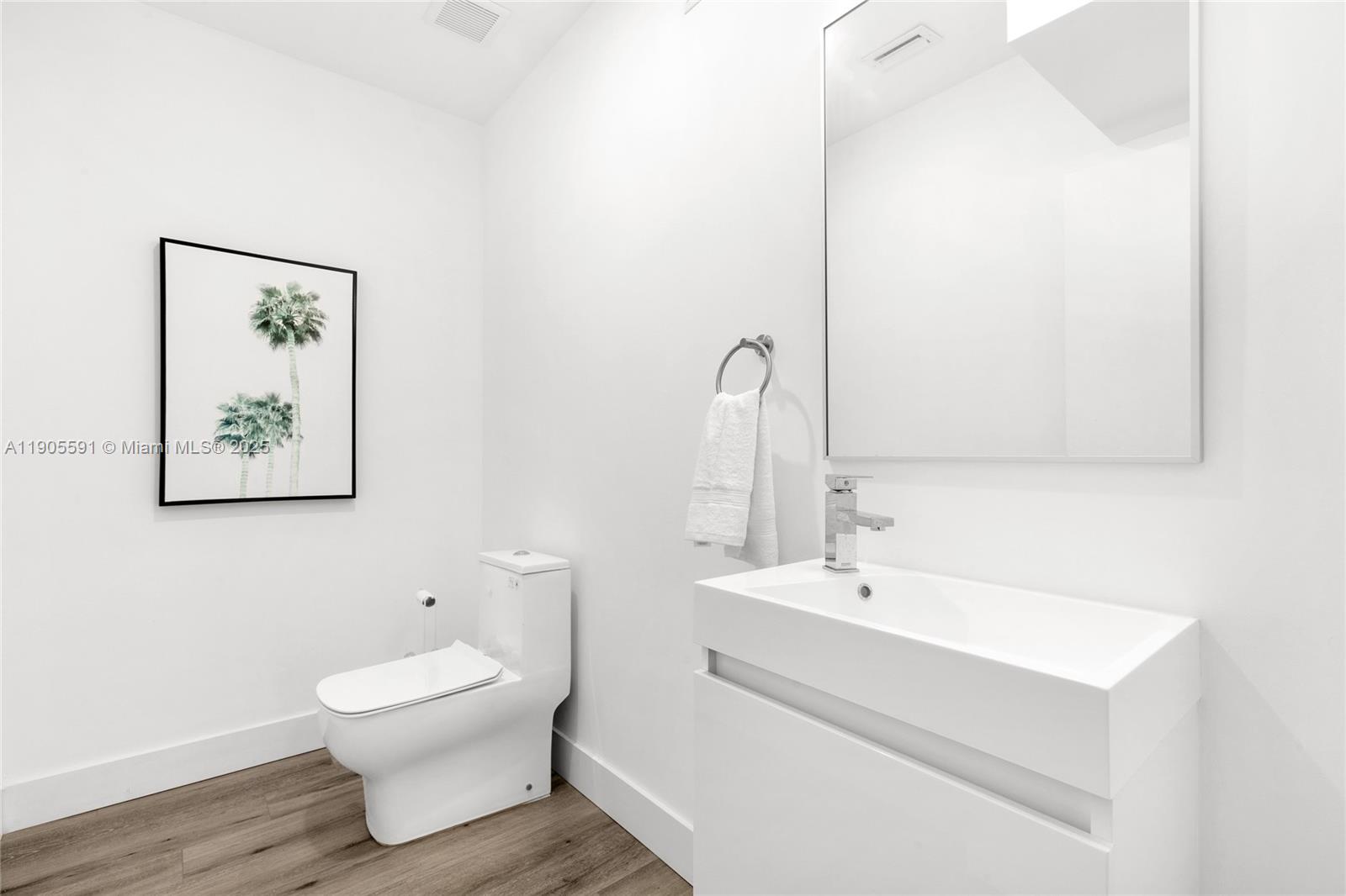 1123 Northeast 23rd Terrace Pompano Beach, FL 33062 - Photo 22 of 35 a bathroom with a toilet sink and mirror