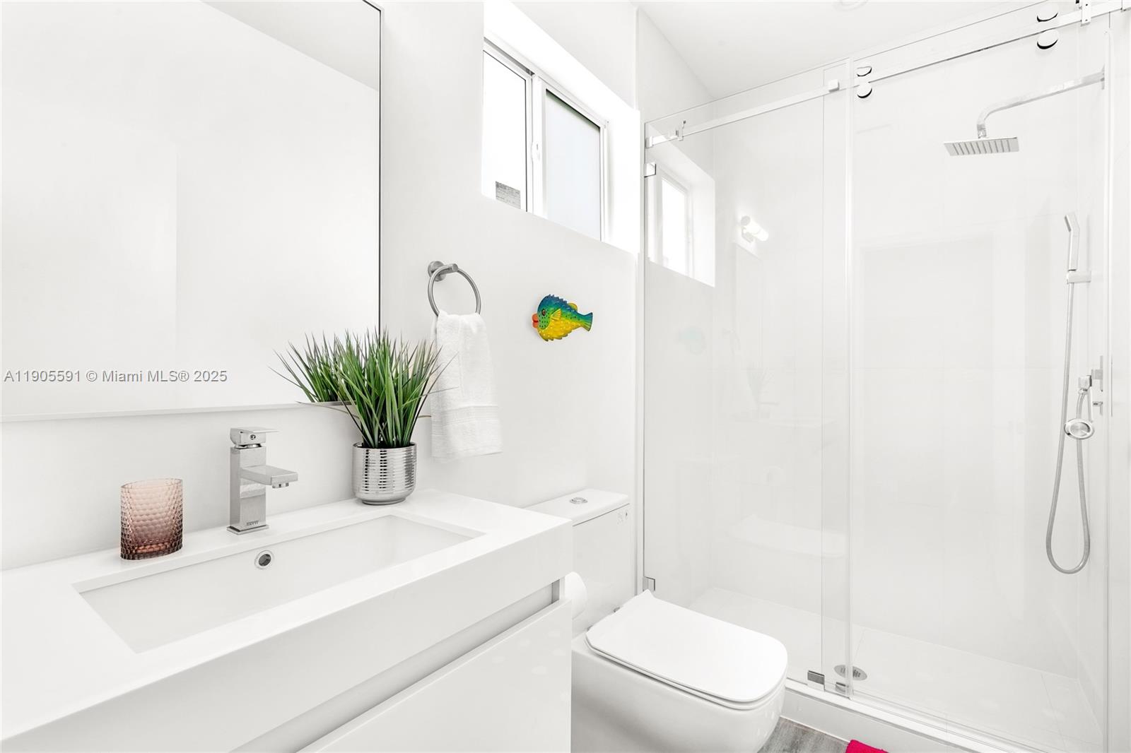 1123 Northeast 23rd Terrace Pompano Beach, FL 33062 - Photo 24 of 35 a bathroom with a granite countertop sink a toilet and shower