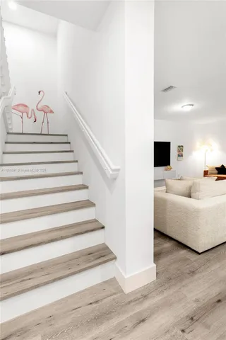 a view of entryway and hall with wooden floor