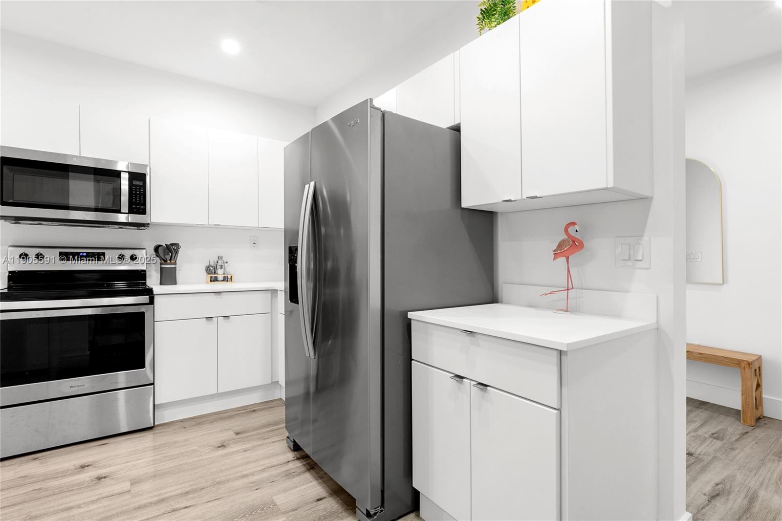 1123 Northeast 23rd Terrace Pompano Beach, FL 33062 - Photo 8 of 35 a kitchen with appliances a sink and a refrigerator