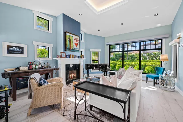 a living room with furniture large window and a fireplace