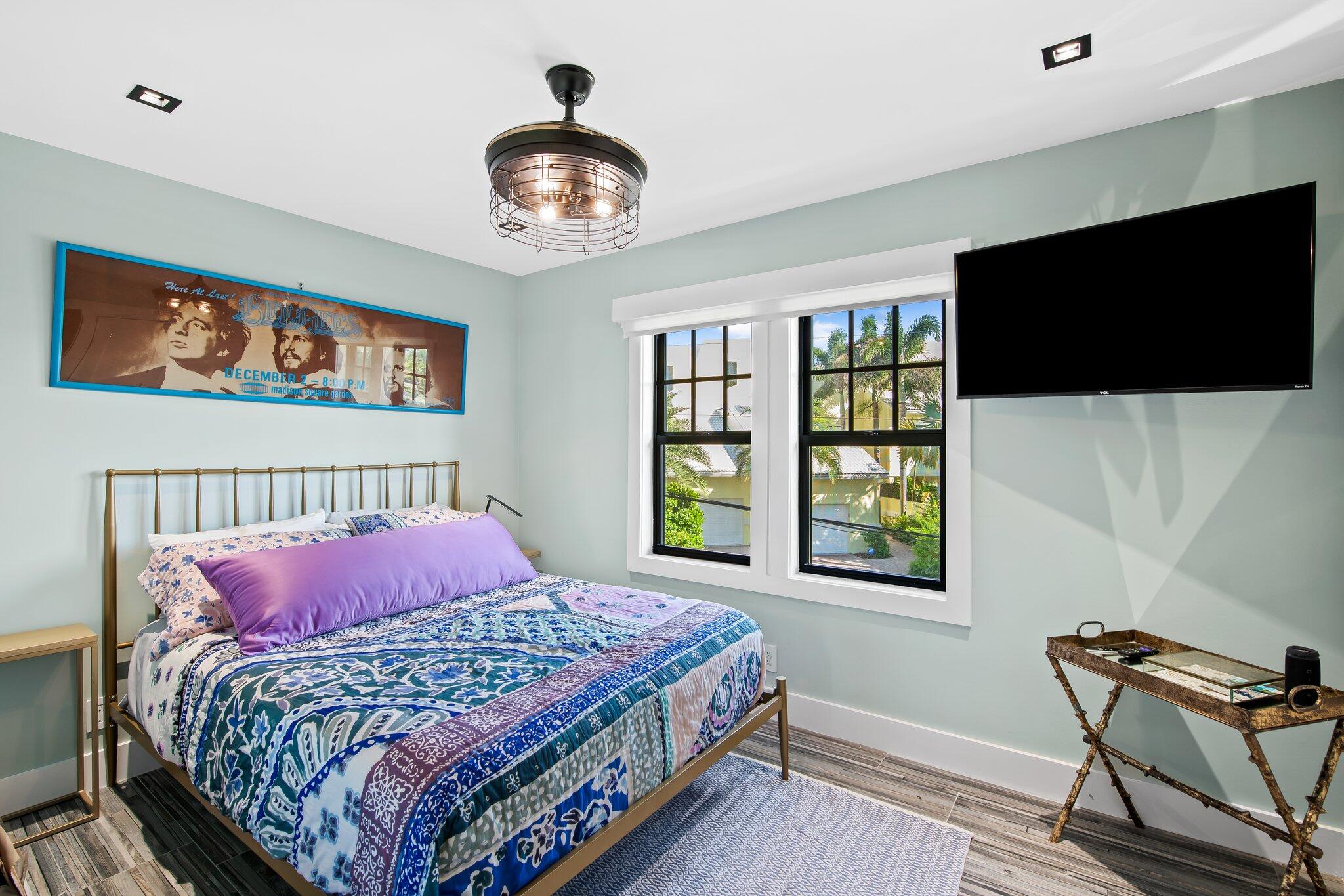 38 Hersey Drive Ocean Ridge, FL 33435 - Photo 27 of 33 a bedroom with a bed and a flat screen tv