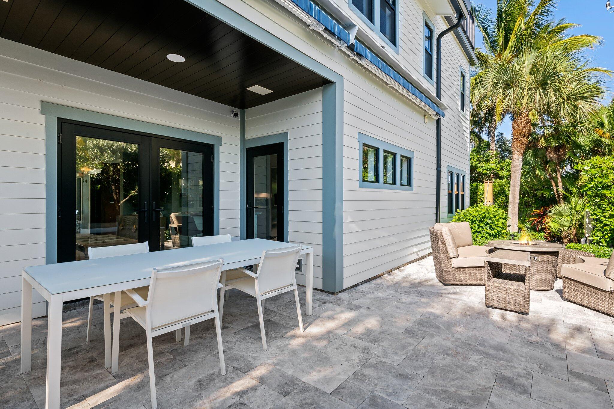 38 Hersey Drive Ocean Ridge, FL 33435 - Photo 7 of 33 a view of a patio with dining table and chairs and potted plants