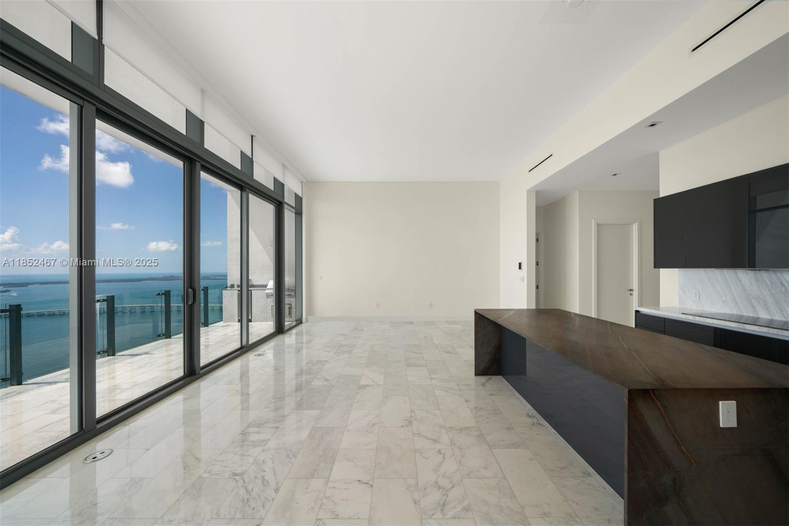 1451 Brickell Avenue, Unit 5302 Miami, FL 33131 - Photo 12 of 25 a living room with large mirror and a flat screen tv