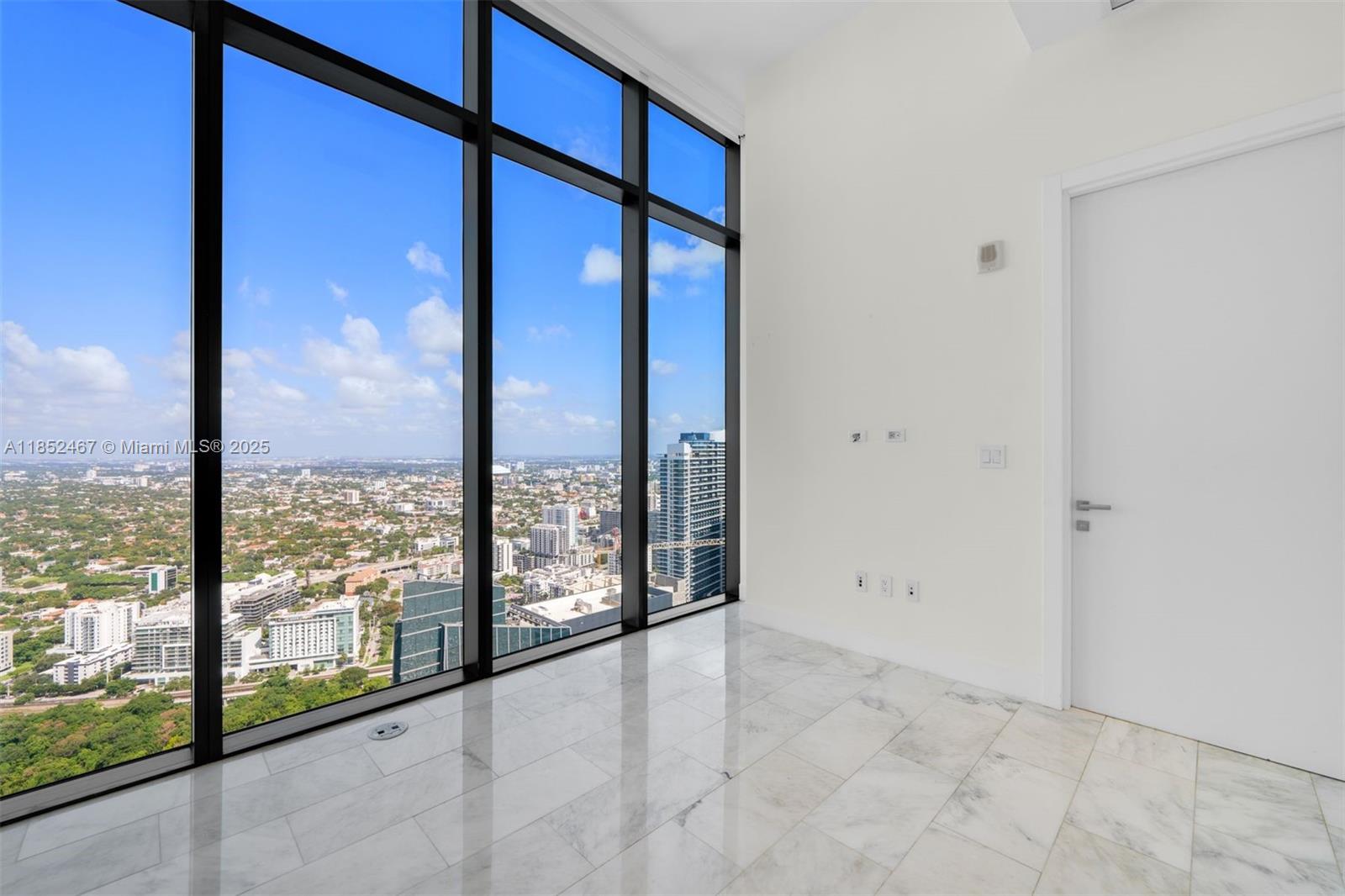 1451 Brickell Avenue, Unit 5302 Miami, FL 33131 - Photo 15 of 25 a view of an empty room and window