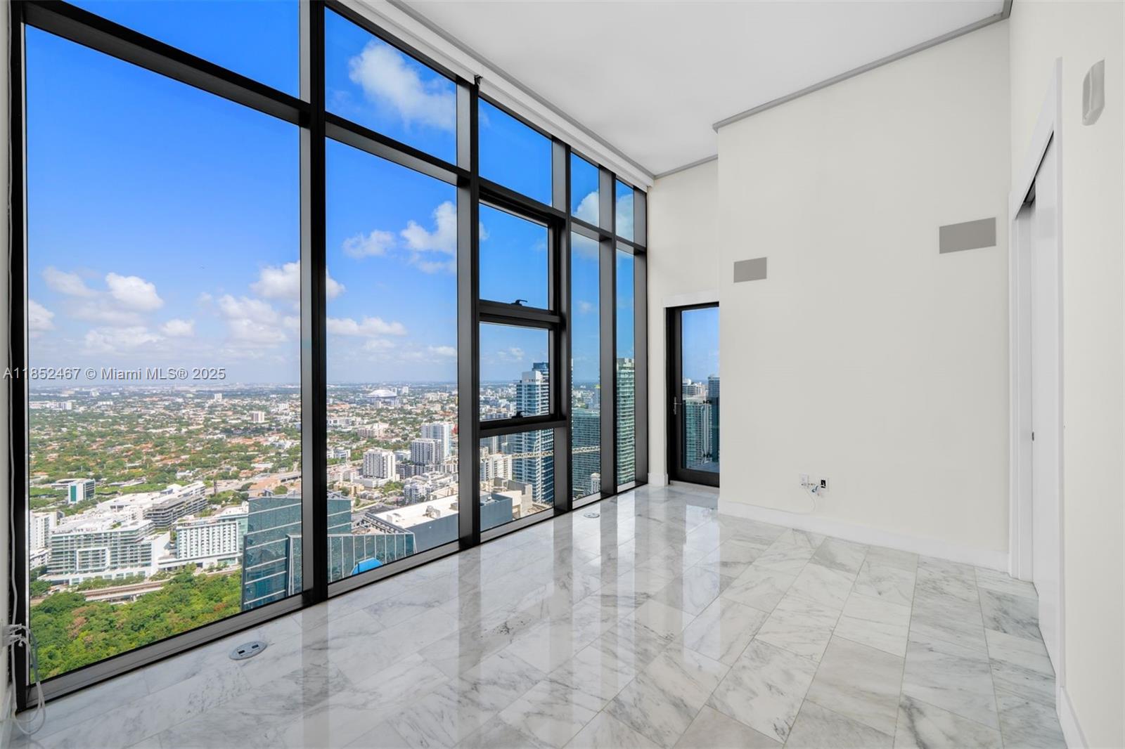 1451 Brickell Avenue, Unit 5302 Miami, FL 33131 - Photo 16 of 25 a view of an empty room with a large window