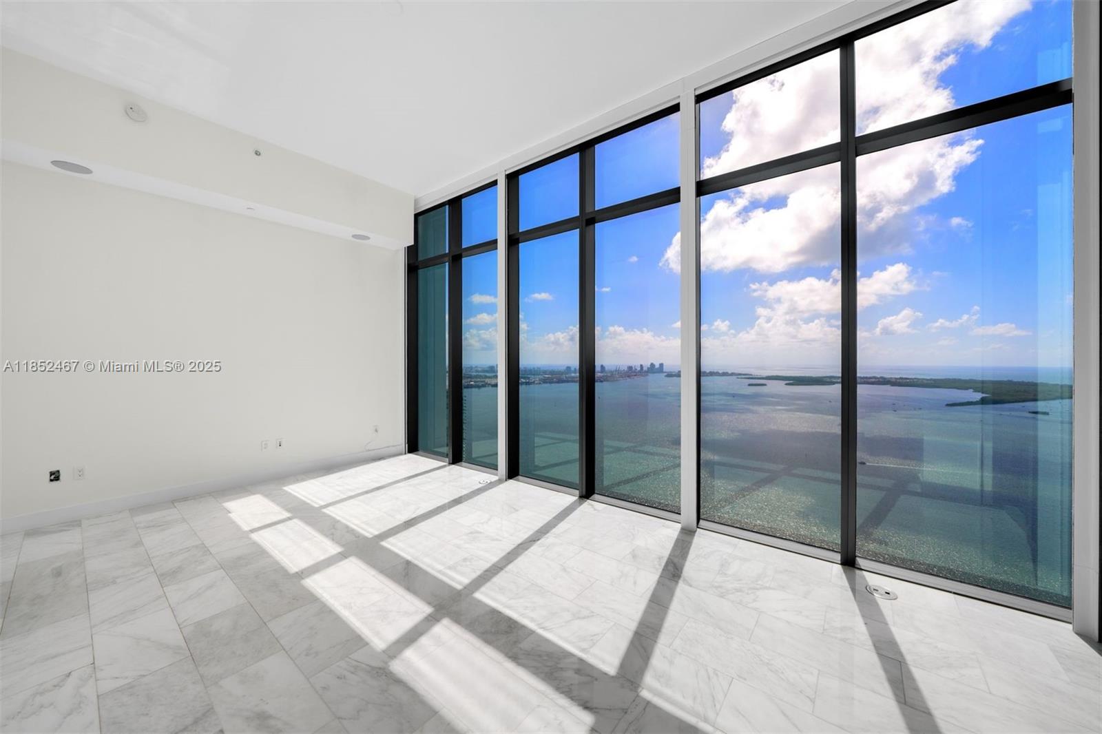 1451 Brickell Avenue, Unit 5302 Miami, FL 33131 - Photo 18 of 25 a bedroom with a large window and a balcony