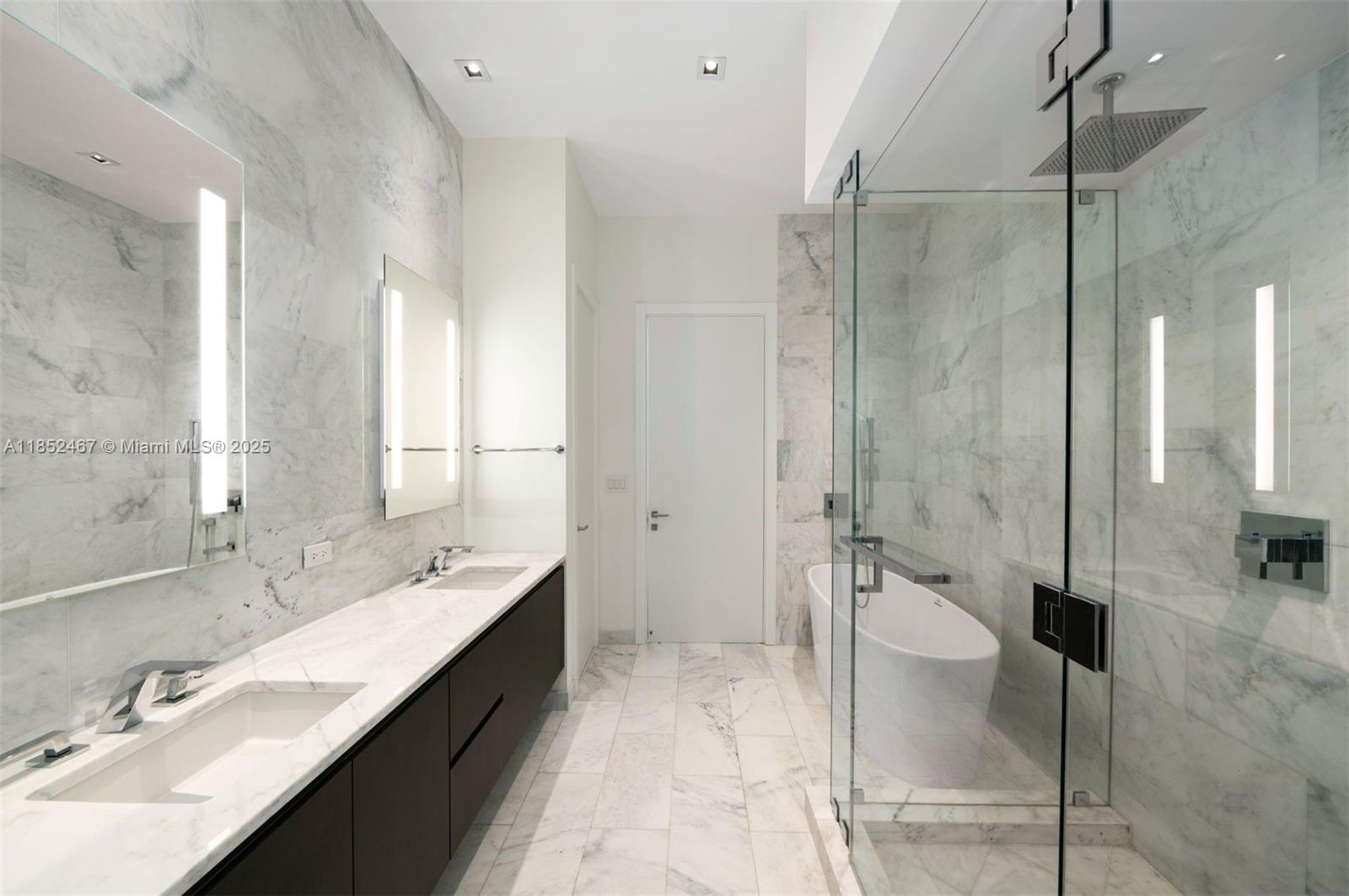 1451 Brickell Avenue, Unit 5302 Miami, FL 33131 - Photo 9 of 25 a spacious bathroom with a double vanity sink toilet mirror and shower