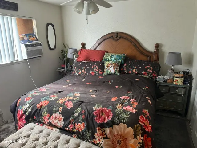 a bedroom with bed and a chandelier