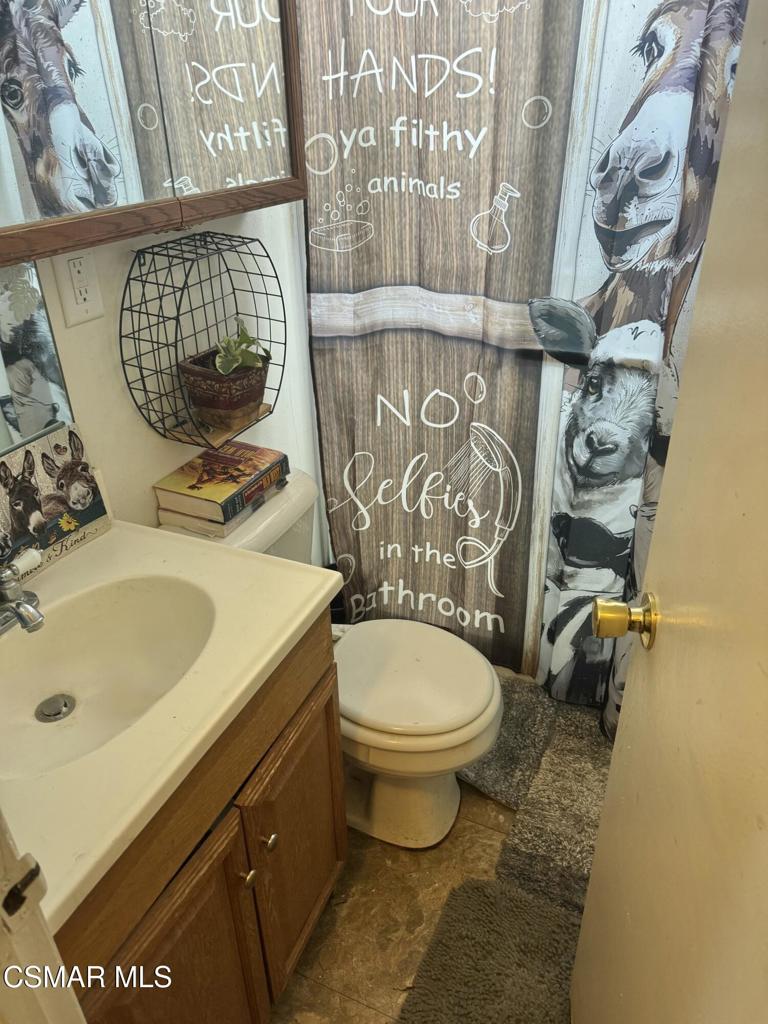 2858 Fitzgerald Road Simi Valley, CA 93065 - Photo 5 of 5 a bathroom with a sink and mirror with toilet