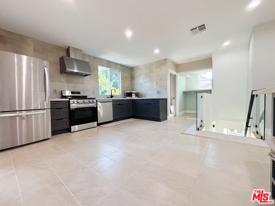 713 Devirian Place Altadena, CA 91001 - Photo 2 of 23 a large kitchen with stainless steel appliances lots of counter space and a refrigerator