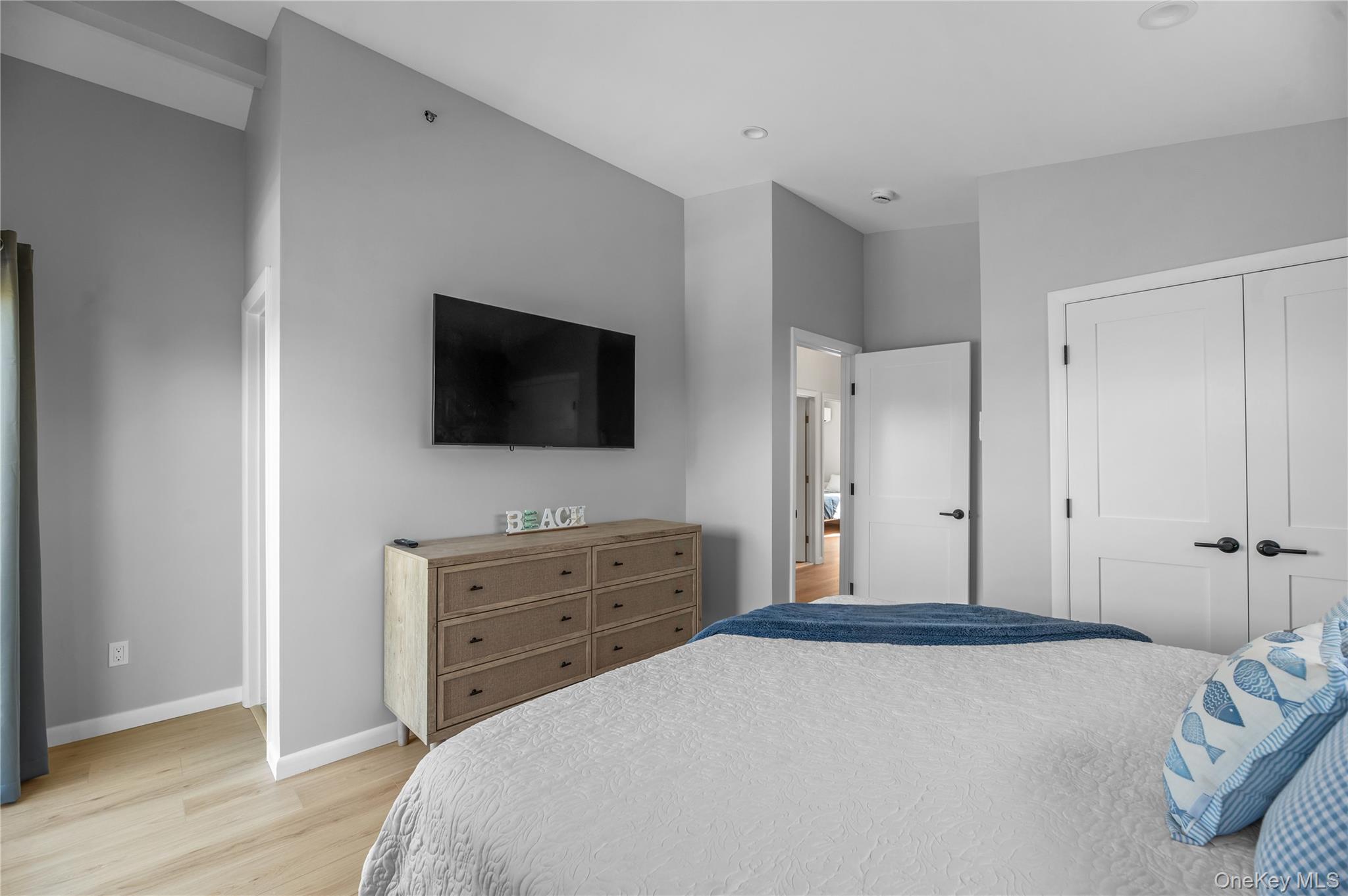 108 Ocean Road Ocean Beach, NY 11770 - Photo 12 of 23 a bedroom with a bed and a flat screen tv