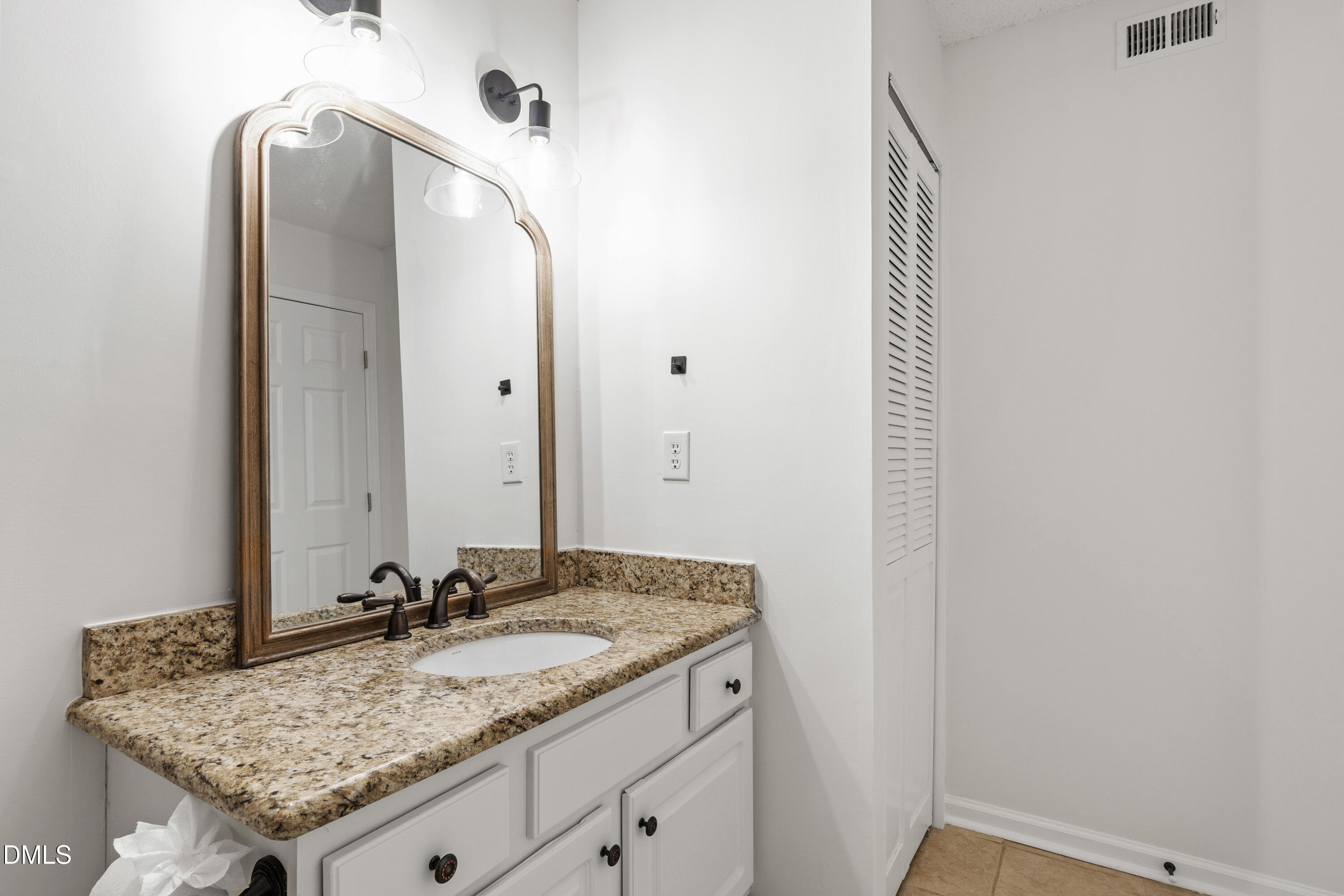911 Washington Street, Unit 301 Raleigh, NC 27605 - Photo 13 of 22 a bathroom with a granite countertop sink and a mirror