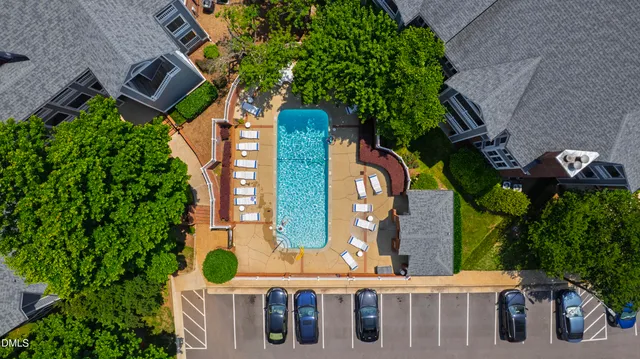 aerial view of a brick house with plants and large trees