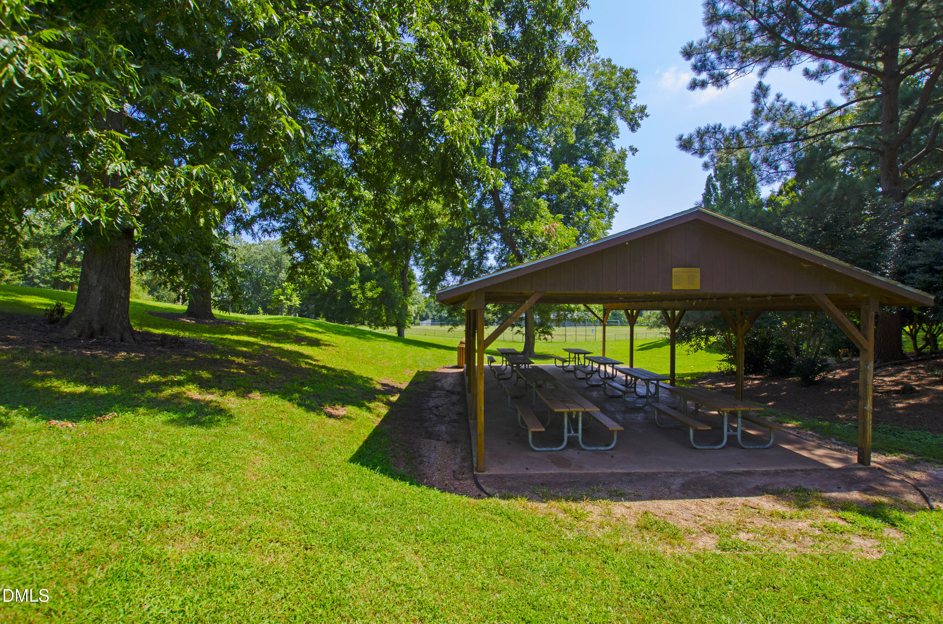 911 Washington Street, Unit 301 Raleigh, NC 27605 - Photo 20 of 22 a view of a yard with table and chairs under an umbrella