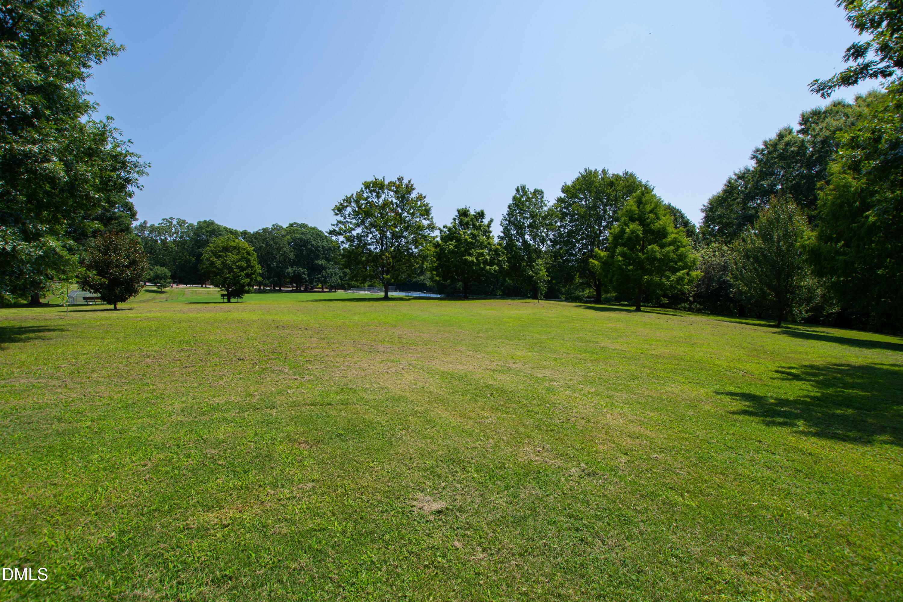 911 Washington Street, Unit 301 Raleigh, NC 27605 - Photo 22 of 22 a view of a green field with a tree in the background