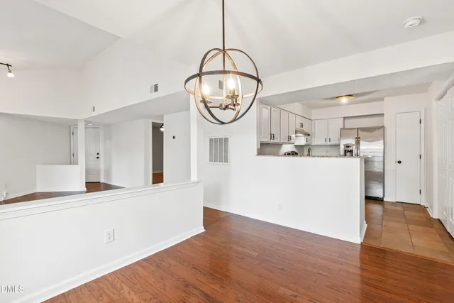 a view of a kitchen with wooden floor and a sink