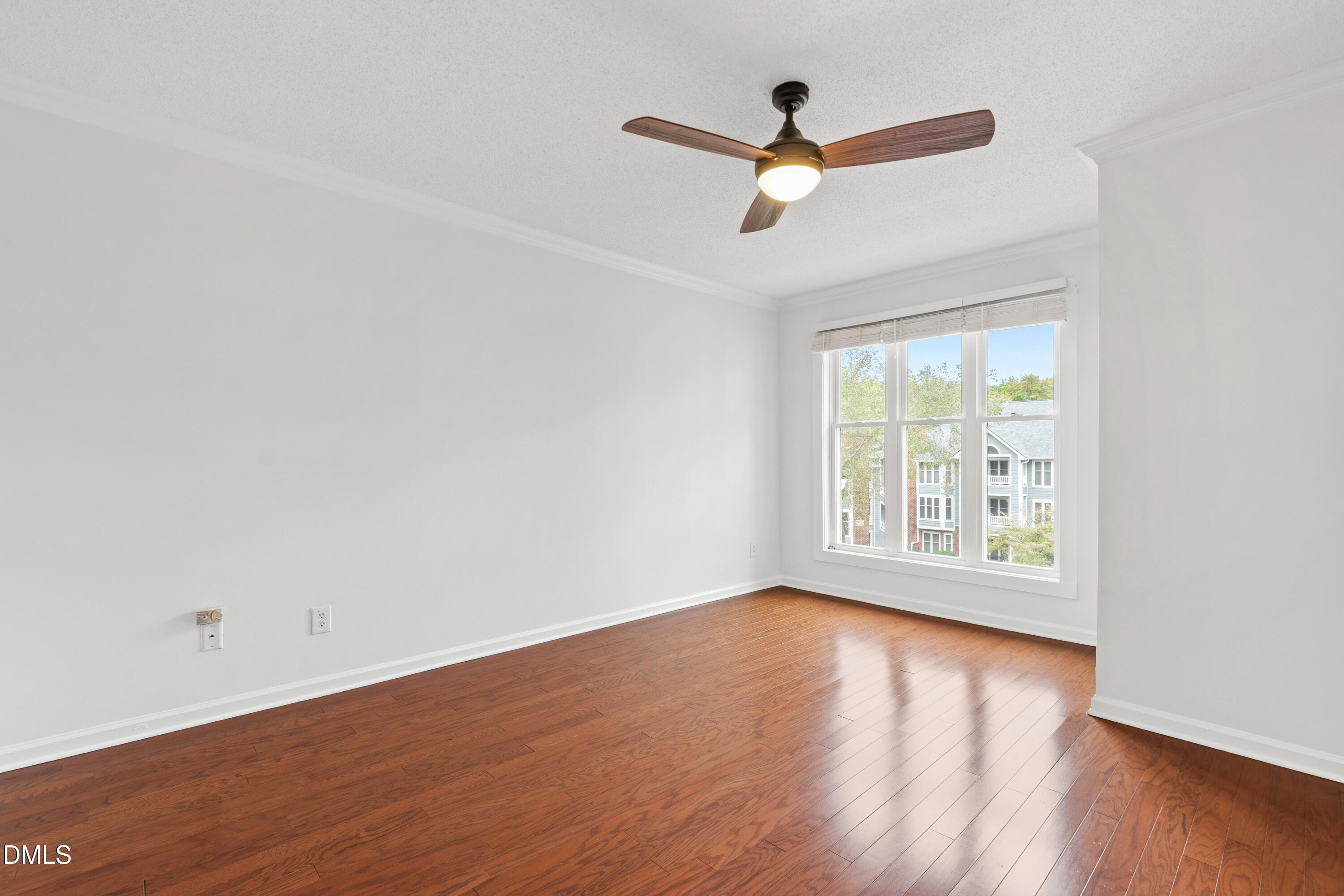 911 Washington Street, Unit 301 Raleigh, NC 27605 - Photo 9 of 22 an empty room with wooden floor and windows