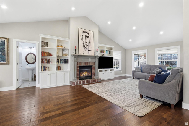 353 Robin Street Smithfield, UT 84335 - Photo 14 of 70 Living room with lofted ceiling, dark wood-type flooring, recessed lighting, and a brick fireplace