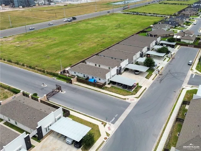 an aerial view of a residential houses with outdoor space